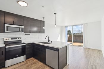 A modern kitchen with a black and white color scheme.